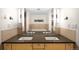 Bathroom with double vanity and a view of the tub from the mirror at 1620 Little Raven St # 109, Denver, CO 80202