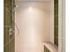 Clean bathroom with a walk in shower and bench at 1620 Little Raven St # 109, Denver, CO 80202