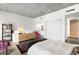 Spacious bedroom with wood dresser, and adjacent bathroom at 1620 Little Raven St # 109, Denver, CO 80202