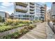 Modern building with landscaped walkway and courtyard at 1620 Little Raven St # 109, Denver, CO 80202