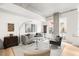 Bright living room with modern furniture, exposed concrete ceiling, and balcony access at 1620 Little Raven St # 109, Denver, CO 80202