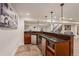 Elegant basement bar with modern appliances and plenty of counter space at 21416 E Ottawa Cir, Aurora, CO 80016