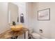 Powder room featuring a unique bowl sink on a granite countertop and a decorative mirror at 21416 E Ottawa Cir, Aurora, CO 80016