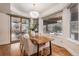 Bright dining area with a wood table, sliding doors to the patio, and large windows at 21416 E Ottawa Cir, Aurora, CO 80016