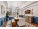 Elegant dining room with a rustic wooden table, designer lighting, and blue wainscoting at 21416 E Ottawa Cir, Aurora, CO 80016