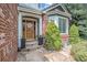 Inviting front entrance with a wood door, brick accents, and manicured landscaping at 21416 E Ottawa Cir, Aurora, CO 80016