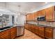 Kitchen with wooden cabinets, stainless steel dishwasher and a sink overlooking an outdoor view at 21416 E Ottawa Cir, Aurora, CO 80016