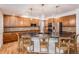 Spacious kitchen features a large island with seating and stainless steel appliances at 21416 E Ottawa Cir, Aurora, CO 80016