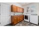 Laundry room with wooden cabinets, a sink and a washer and dryer at 21416 E Ottawa Cir, Aurora, CO 80016
