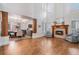 Spacious living room with hardwood floors, a fireplace, and an open layout to dining area at 21416 E Ottawa Cir, Aurora, CO 80016