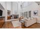Bright living room with fireplace, large windows and plantation shutters at 21416 E Ottawa Cir, Aurora, CO 80016
