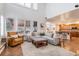 Bright living room with large windows, plantation shutters and an open view into the kitchen at 21416 E Ottawa Cir, Aurora, CO 80016