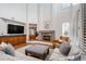Living room with a fireplace and a large television above wooden cabinets at 21416 E Ottawa Cir, Aurora, CO 80016