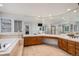 Large main bathroom features a corner tub, walk-in shower, and a vanity with a large mirror at 21416 E Ottawa Cir, Aurora, CO 80016