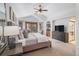 Spacious main bedroom featuring vaulted ceilings, a ceiling fan and an ensuite bath with double doors at 21416 E Ottawa Cir, Aurora, CO 80016