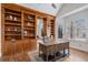 Cozy office with custom built-in bookshelves and a rustic industrial-style desk at 21416 E Ottawa Cir, Aurora, CO 80016