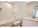 Modern bathroom with a tiled shower over the tub, wood-look flooring, and white vanity with a large mirror at 15296 Fillmore St, Thornton, CO 80602