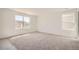 Spacious bedroom with plush carpeting, bright windows, and plenty of natural light at 15296 Fillmore St, Thornton, CO 80602