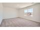 Bright, spacious bedroom featuring plush carpeting and a large window that provides plenty of natural light at 15296 Fillmore St, Thornton, CO 80602
