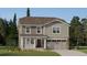 Charming two-story home featuring stone accents, neutral siding, covered porch, and attached two-car garage at 15296 Fillmore St, Thornton, CO 80602