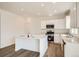 Bright kitchen featuring white cabinets, stainless steel appliances, and a center island with a white countertop at 15296 Fillmore St, Thornton, CO 80602