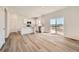 Open-concept living area flowing into a modern kitchen with a sliding glass door for abundant natural light at 15296 Fillmore St, Thornton, CO 80602