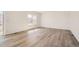 Bright and airy living room with wood-look flooring and ample natural light from the large sliding glass door at 15296 Fillmore St, Thornton, CO 80602