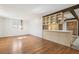 Kitchenette features exposed beams, track lights, wood cabinets and a tiled transition to hardwood floors at 2567 Benton St, Edgewater, CO 80214