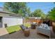 Backyard patio with outdoor seating, fire pit, grill, and artificial grass at 2571 S Cherokee St, Denver, CO 80223