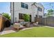 Backyard patio featuring outdoor seating, a fire pit, and lush landscaping at 2571 S Cherokee St, Denver, CO 80223