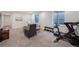 Finished basement area featuring seating, gym equipment, and natural light at 2571 S Cherokee St, Denver, CO 80223