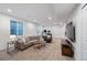 Basement living area with comfortable seating, natural light, and neutral tones at 2571 S Cherokee St, Denver, CO 80223