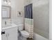 Modern bathroom with white vanity, hexagon tile shower, and contemporary fixtures at 2571 S Cherokee St, Denver, CO 80223