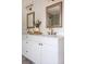 Elegant bathroom vanity with double sinks, modern fixtures and bright lighting at 2571 S Cherokee St, Denver, CO 80223