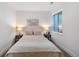 Cozy bedroom with neutral tones, comfortable bed, and natural light from window at 2571 S Cherokee St, Denver, CO 80223