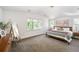 Light-filled bedroom with plush carpet, neutral decor, and view of the outside scenery at 2571 S Cherokee St, Denver, CO 80223