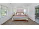 Bright primary bedroom with modern decor, hardwood floors, and ensuite bathroom at 2571 S Cherokee St, Denver, CO 80223