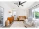 Bedroom featuring a crib, soft carpet, modern ceiling fan, and natural light at 2571 S Cherokee St, Denver, CO 80223