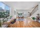 Bright and airy dining room featuring a wooden table, staircase access, and a home office setup near a window at 2571 S Cherokee St, Denver, CO 80223