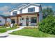 Charming two-story home with modern farmhouse appeal, a welcoming porch and well-manicured landscaping at 2571 S Cherokee St, Denver, CO 80223
