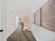 Upstairs hallway with carpet flooring, art-lined walls, and natural light at 2571 S Cherokee St, Denver, CO 80223