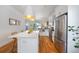 Modern kitchen with a large island, stainless steel appliances, and bright pendant lighting, perfect for cooking at 2571 S Cherokee St, Denver, CO 80223