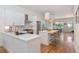Open concept kitchen with a large island, stainless steel appliances and hardwood floors throughout at 2571 S Cherokee St, Denver, CO 80223