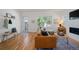 Cozy living room with a leather couch, hardwood floors, and natural light from a large window at 2571 S Cherokee St, Denver, CO 80223