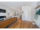 Open-concept living room with modern decor, hardwood floors, and seamless kitchen access at 2571 S Cherokee St, Denver, CO 80223