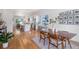 Open-concept living and dining area featuring hardwood floors, modern furnishings, and abundant natural light at 2571 S Cherokee St, Denver, CO 80223