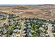 Beautiful aerial view of a residential community with lush green trees and open land nearby at 1805 Parkdale N Cir, Erie, CO 80516