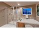 Bathroom showcasing a soaking tub, glass-enclosed shower, and tile flooring at 1805 Parkdale N Cir, Erie, CO 80516