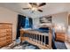 Bedroom features hardwood floors, a wooden bed frame, and matching bedside tables at 1805 Parkdale N Cir, Erie, CO 80516