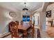 Elegant dining room featuring hardwood floors, a decorative light fixture, and a large window for natural light at 1805 Parkdale N Cir, Erie, CO 80516